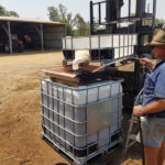 Stephen preps tanks of bio fertiliser by adding water